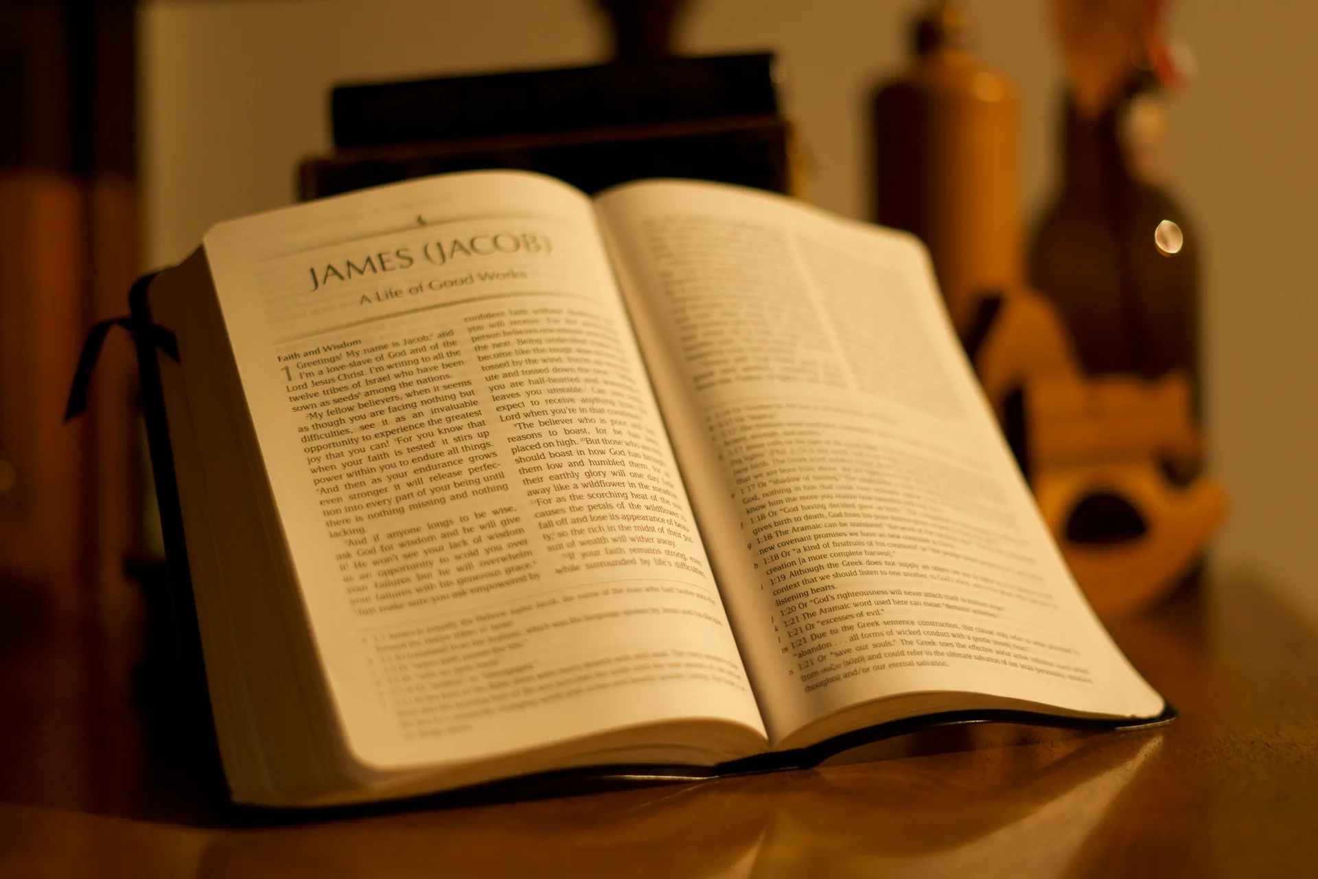 Close-up of open Bible on wooden table with warm natural lighting